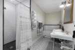 Full bathroom in the caretakers suite has a walk-in shower, separate tub, double vanity, and toilet closet